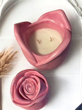 Load image into Gallery viewer, Pink rosebud coconut wax candle in a pink rose shape container, labeled "mermaid Glow Edition", styled with pink petals