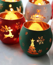 Load image into Gallery viewer, Set of Christmas tealight holders glowing with gold reindeer and tree designs on red and green frosted glass.