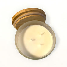 Load image into Gallery viewer, Top view of three-wick coconut wax candle in frosted jar with open bamboo lid.”