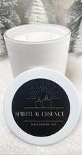 A white matte glass candle container with a lid, featuring a tobacco and vanilla fragrance candle, with a label that reads 'Spiritual Essence & Blessings.co'.