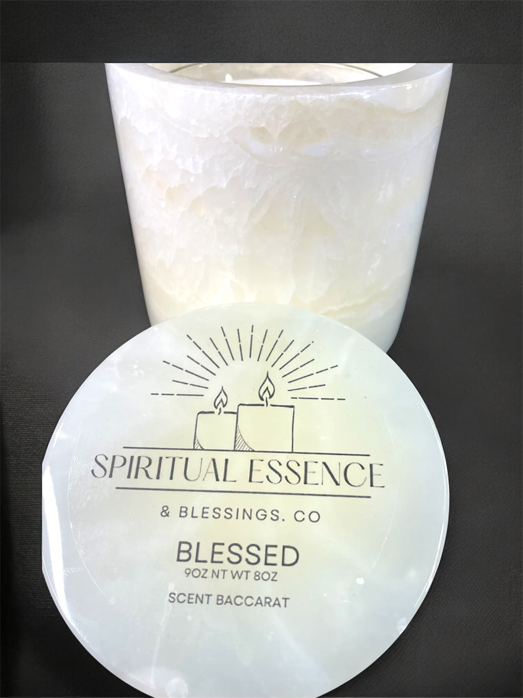 Luxury Blessed candle by Spiritual Essence & Blessings Co. in milky white onyx-style vessel with black background.