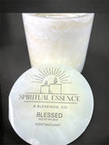 Luxury Blessed candle by Spiritual Essence & Blessings Co. in milky white onyx-style vessel with black background.