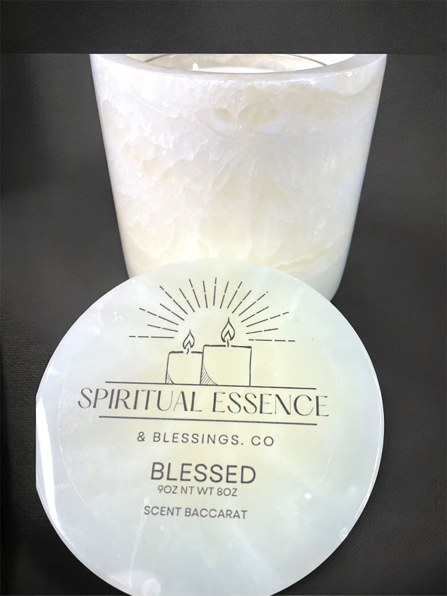 Luxury Blessed candle by Spiritual Essence & Blessings Co. in milky white onyx-style vessel with black background.