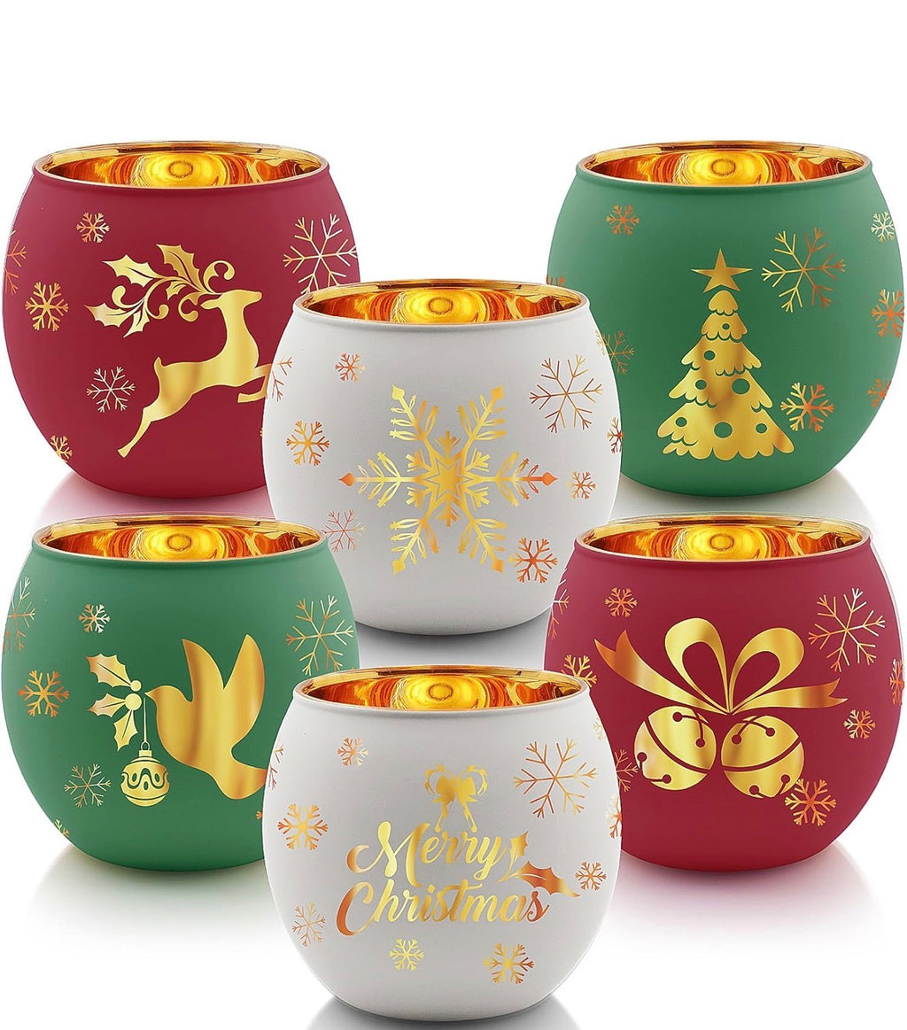Frosted Christmas candle holders in red, green, and white with gold interior reflecting warm candlelight.