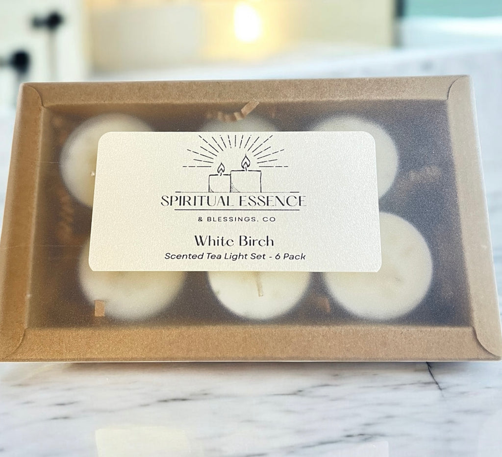 Box of White Birch scented tea light candles with 'Spiritual Essence & Blessings Co' label on a marble surface.