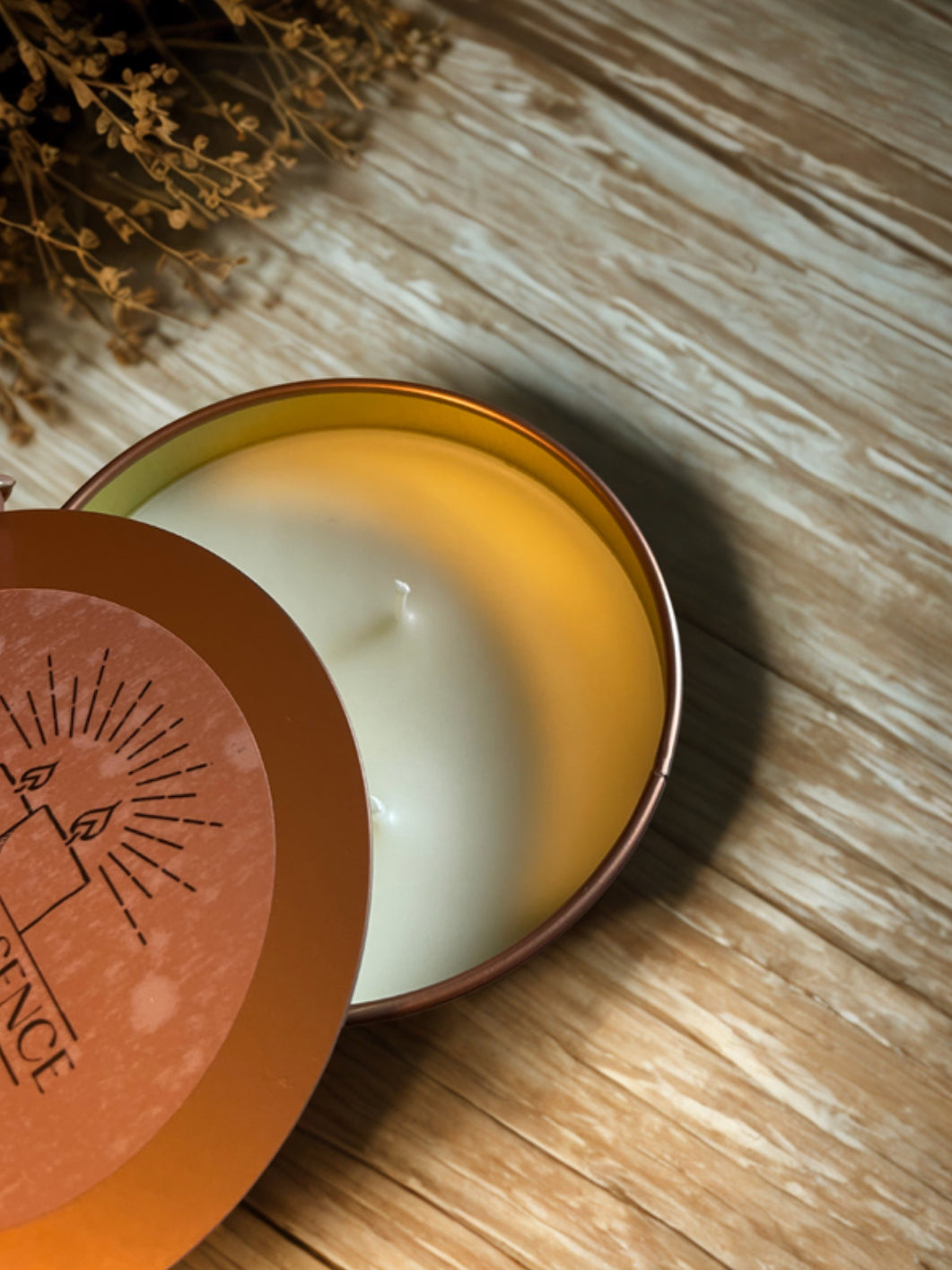 Triple-wick butterscotch candle in warm copper tin on wooden table — cozy fall home fragrance