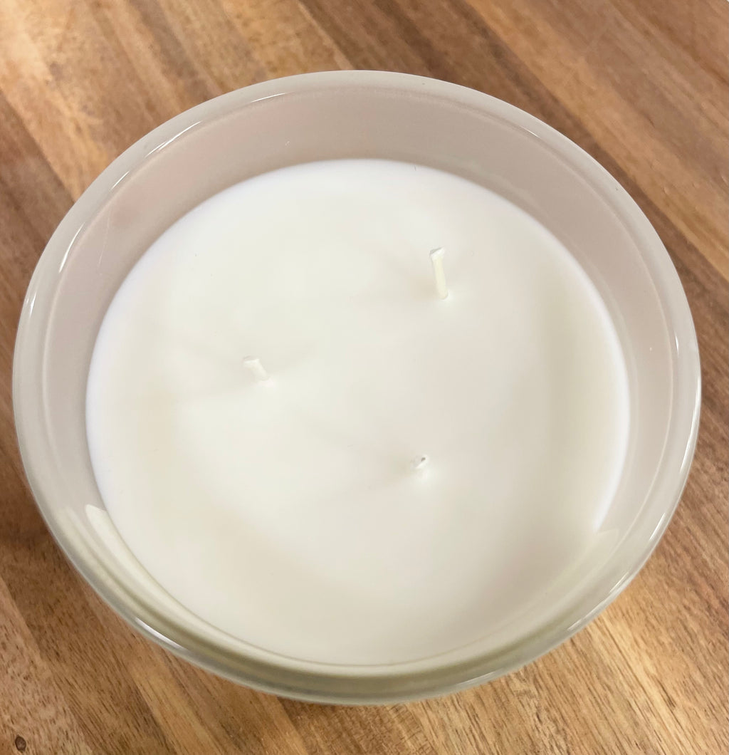Overhead view of triple-wick mahogany candle in frosted glass jar