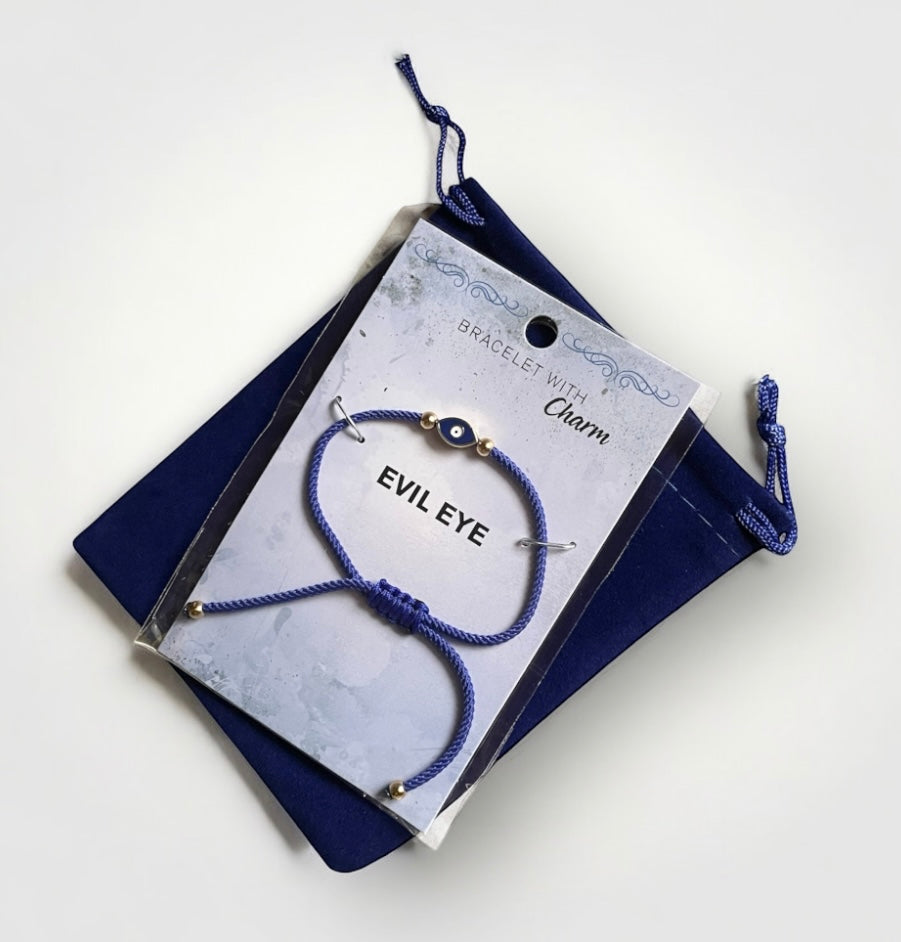 Blue bracelet with 'Evil Eye' charm on a branded card against a white background